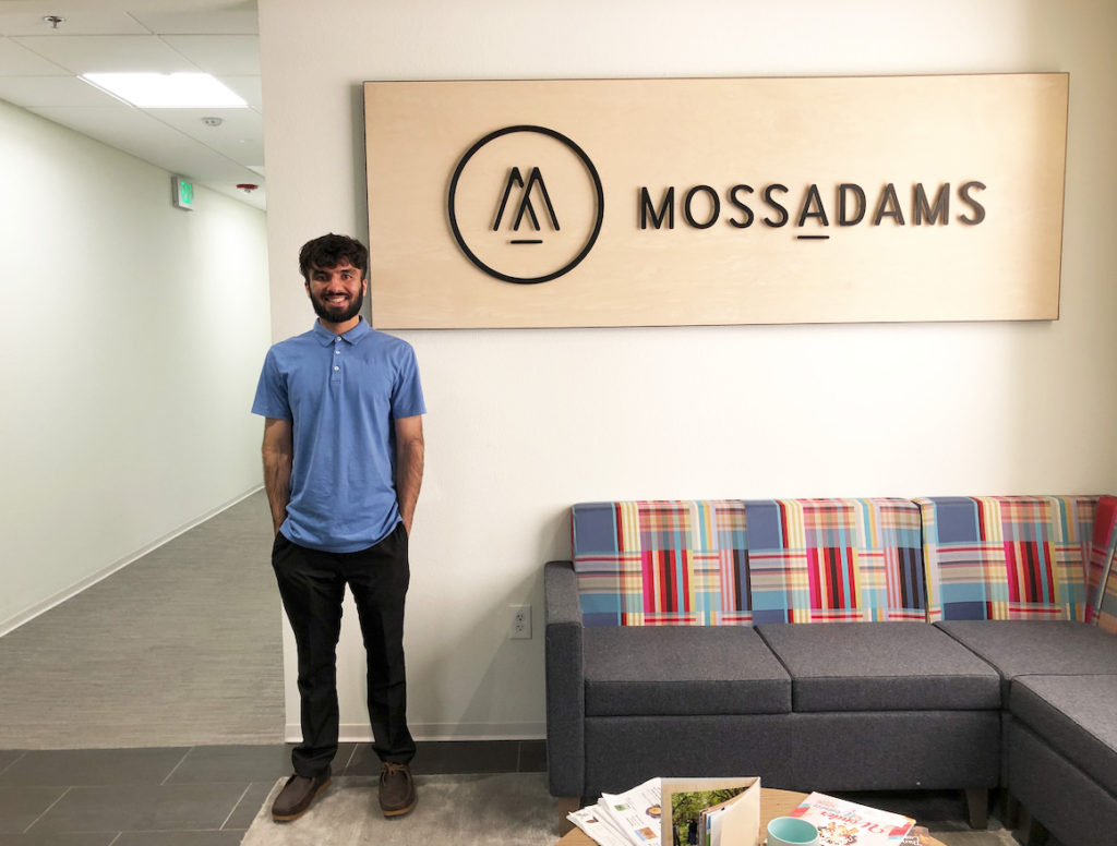 Accounting student Aaron Gill poses at his internship at Moss Adams. 