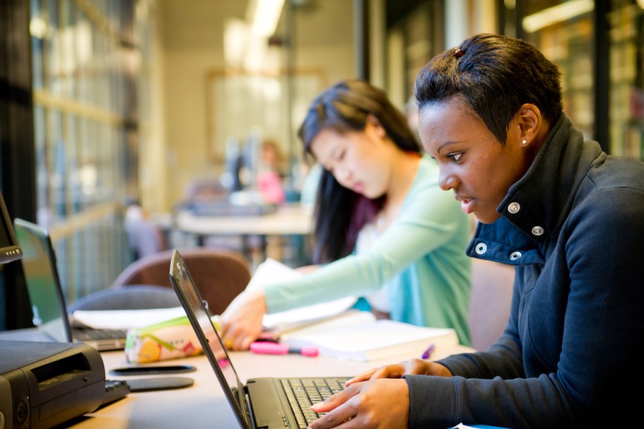 Two students studying in a library.