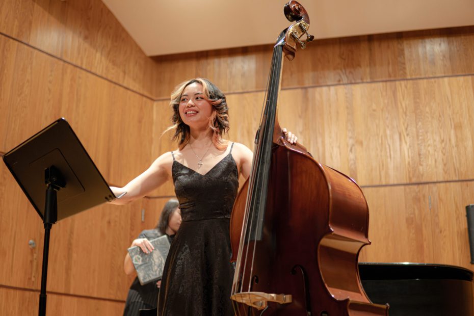 Julianna Meneses holding her double bass and