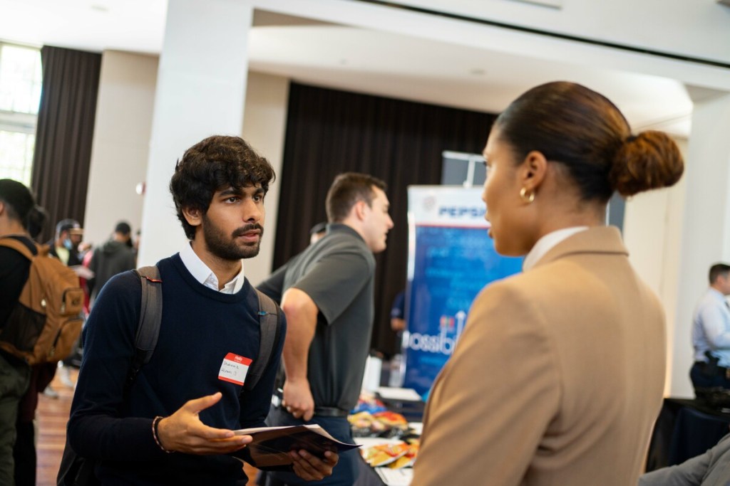 Pacific student speaks with employer at Meet the Firms day 2022. 
